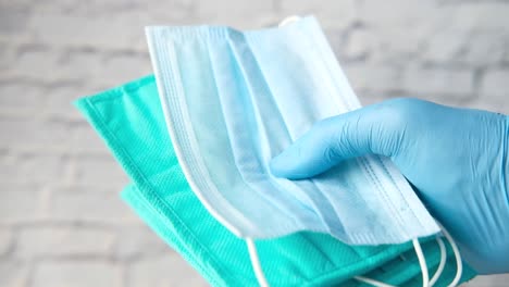 handful of blue and green surgical masks