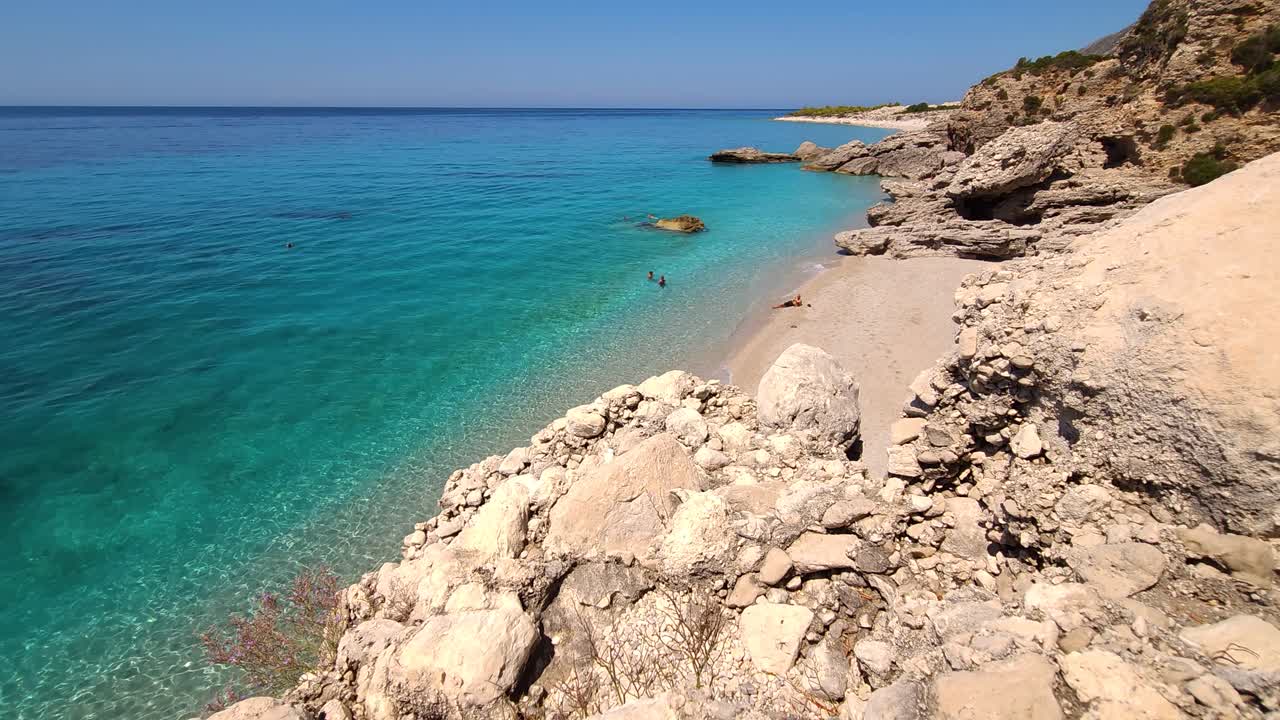 Amazing beach scene with summer colors of blue turquoise sea and white sand beach surrounded by cliffs in Mediterranean