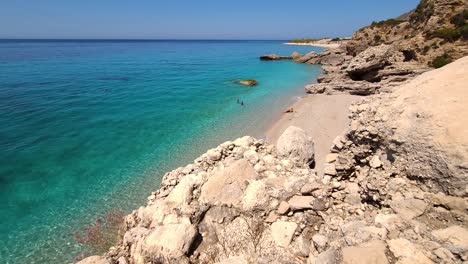 amazing beach scene with summer colors of blue turquoise sea and white sand beach surrounded by cliffs in mediterranean