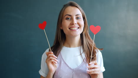 woman holding heart-shaped props