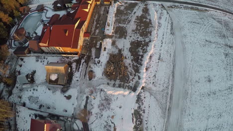 Aerial-shot-of-village-with-houses-and-snowy-fields-in-Russia