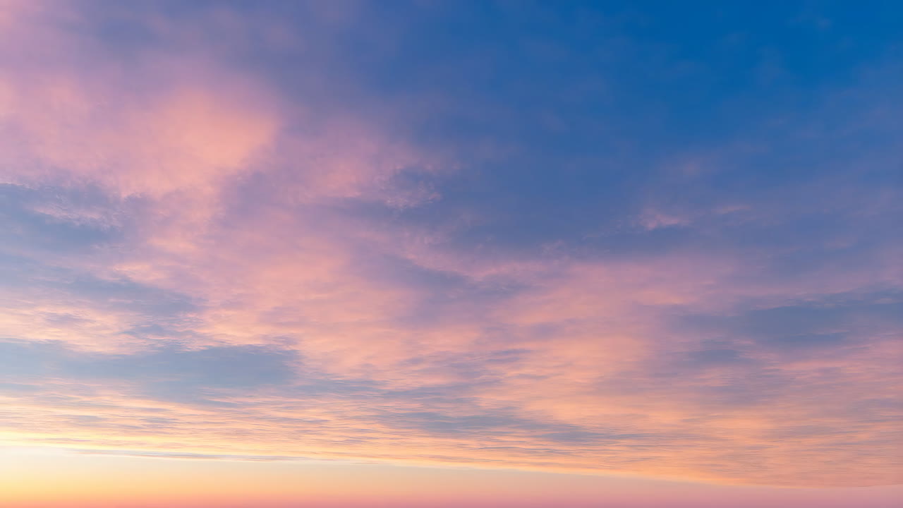 Beautiful sunset sky with pink and blue clouds