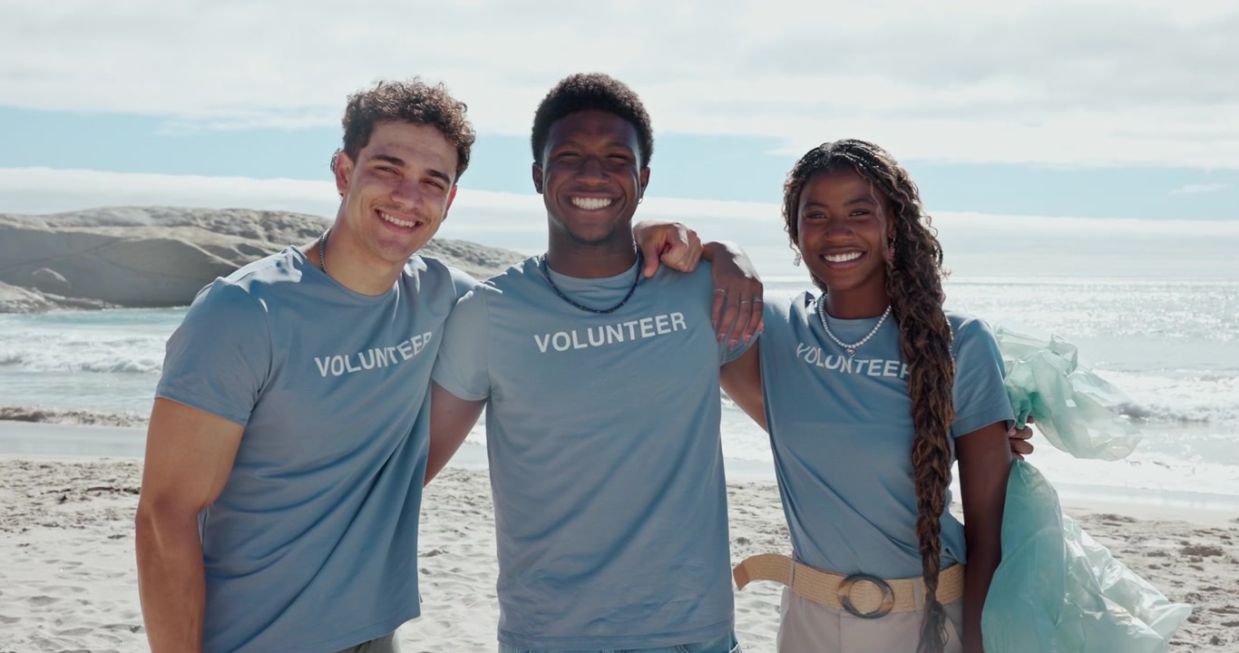 Diverse Group of Volunteers Smiling Together on a Beach