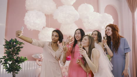 group of friends taking a selfie with smartphone at a bachelorette party