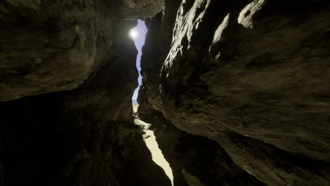 sunlight streaming through rock formations at a coastal canyon