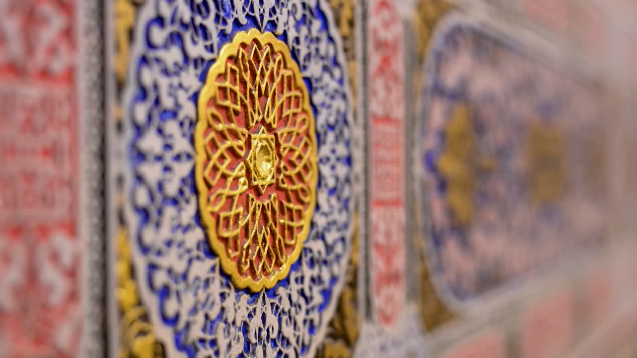 Close-up of intricate decorative art, possibly historic Islamic or Mudéjar patterns, showcasing exquisite craftsmanship from the Aranjuez Royal Palace museum exhibition in Spain.