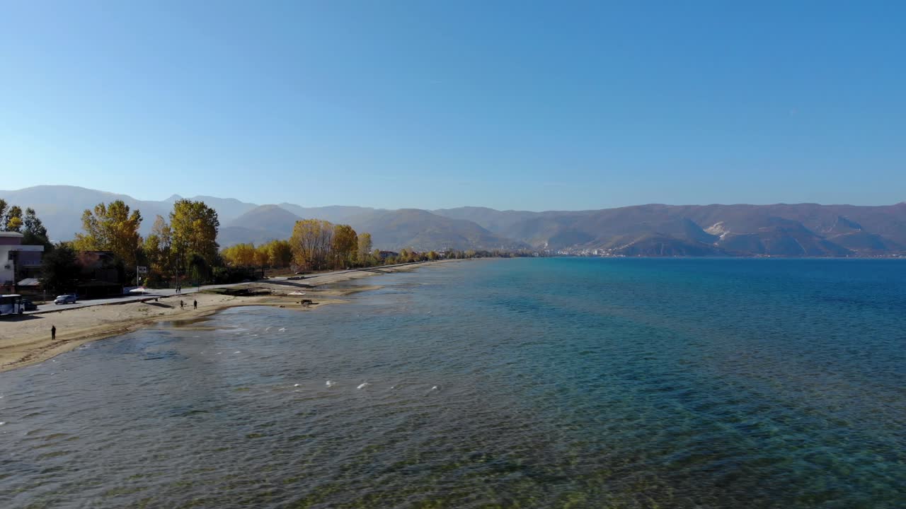 Fishing boats and people enjoying sunny Autumn morning on shore of Ohrid lake