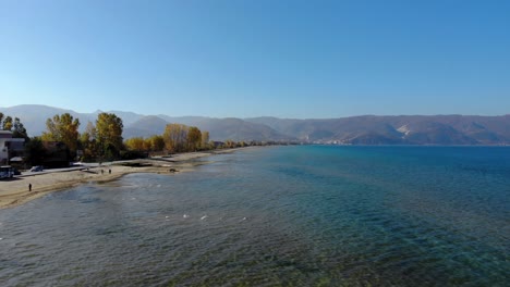 fishing boats and people enjoying sunny autumn morning on shore of ohrid lake