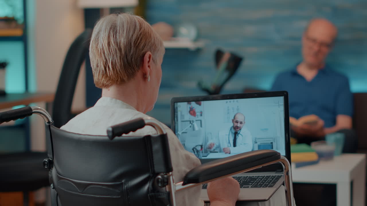 Senior Woman Using Telemedicine on Laptop While in Wheelchair
