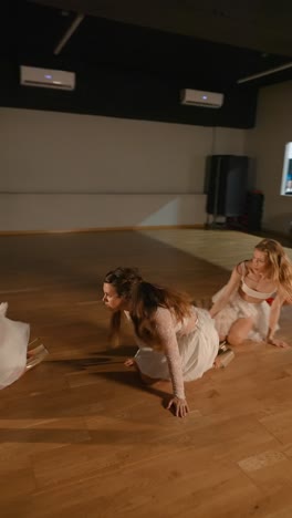three women in white performing contemporary dance