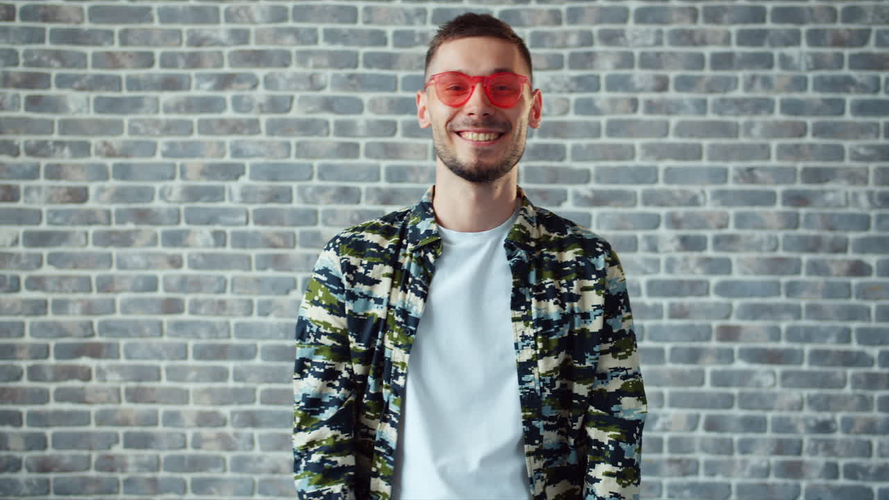 Man with Red Glasses in Camouflage Shirt