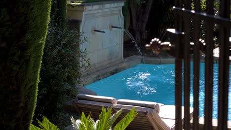 beautiful outdoor pool with fountain in a garden of a luxurious castle in southern france