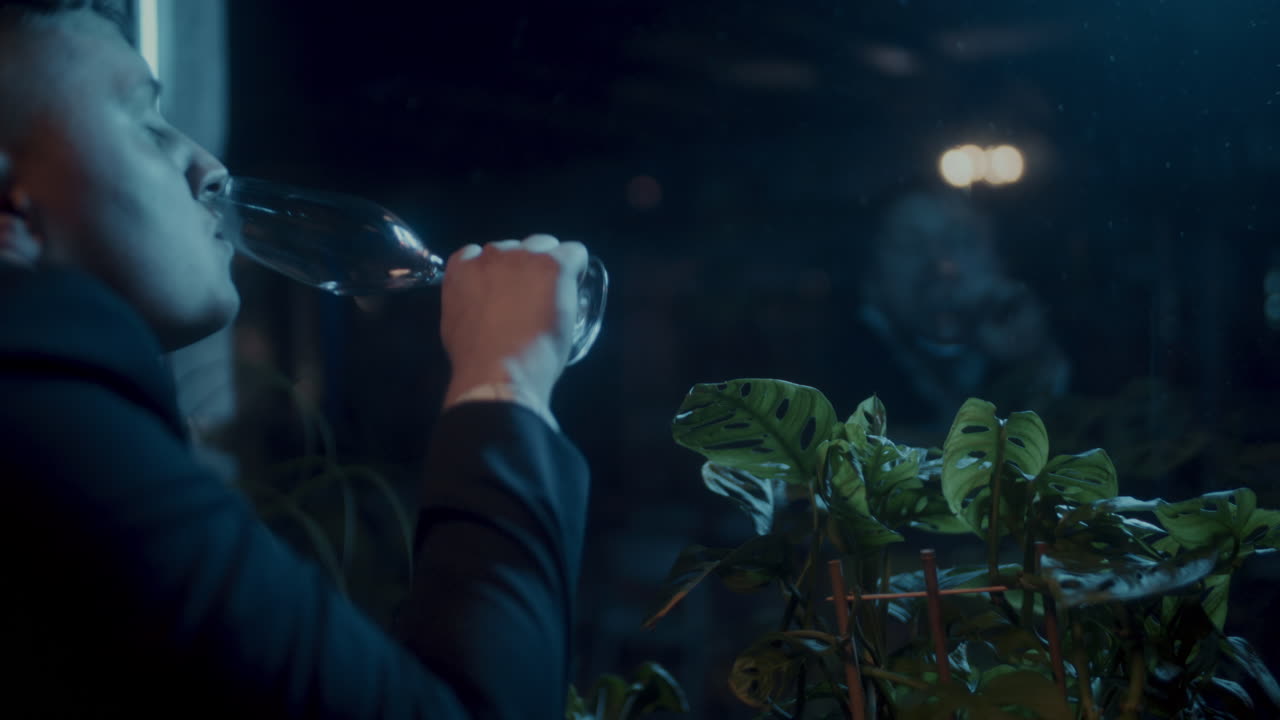 Man drinking champagne at night