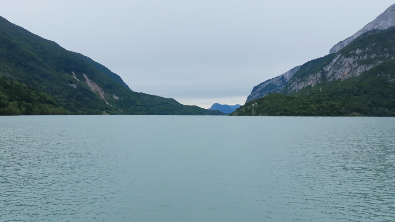Aerial footage flying across the lake outside of the town of Molveno in northern Italy.