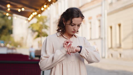 scared woman worrying to be punctual, with anxiety checking time on watch, running late to work