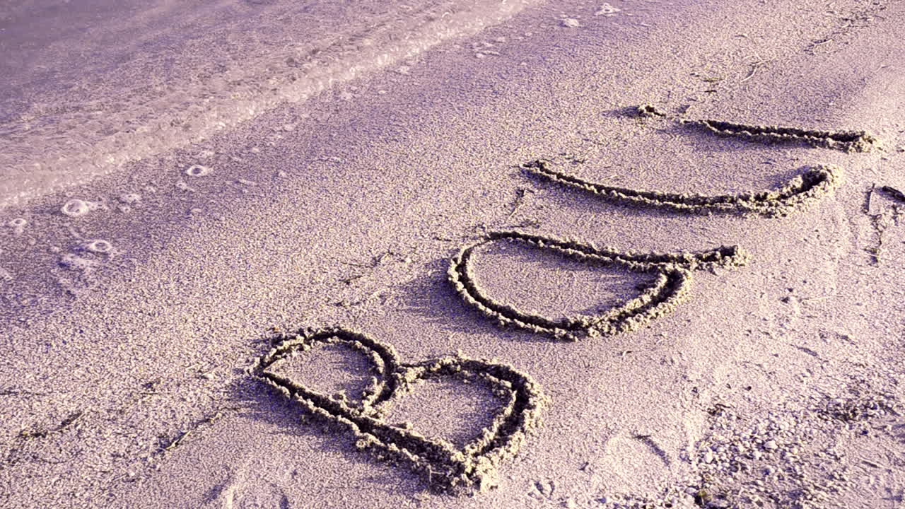 Inscription Bali on sandy beach. Inscription on sand, the beach