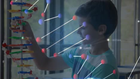 dna structure moving against against boy holding 3d dna model in laboratory