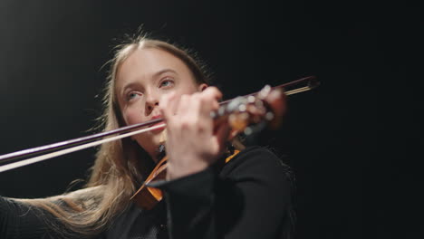 inspired female fiddler is playing classic music concert in philharmonic hall violinist is playing fiddle