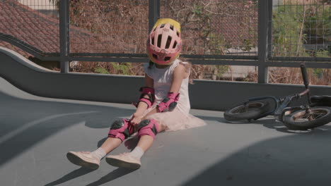 girl fooling around while resting after riding a bicycle