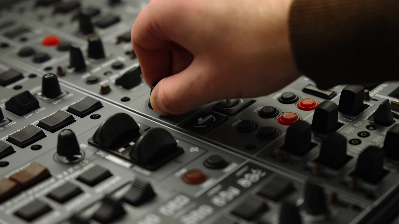 Closeup Hand Adjusting Audio Mixer Controls Sound Engineer Finetuning Levels On Analog Console, Tactile Knob