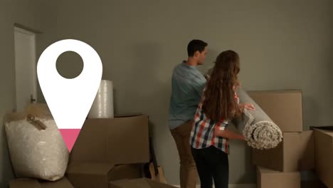 animación de la marca de destino sobre una feliz pareja caucásica que se muda a una nueva casa