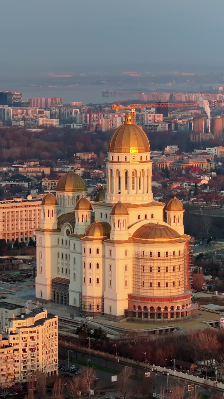 Vertical aerial drone view of People's Salvation Cathedral near the Palace of the Parliament. Sunset in Bucharest, Romania