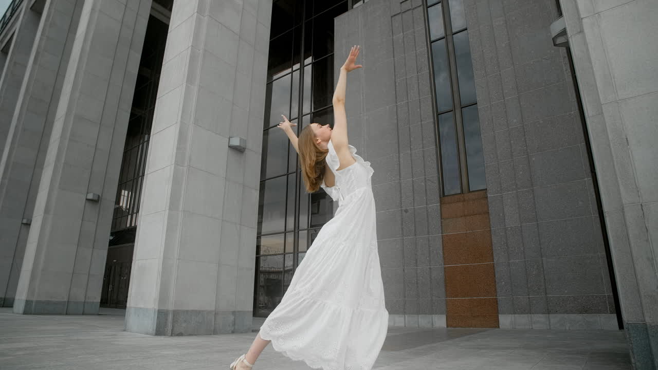 Woman Dancing in Front of a Modern Building