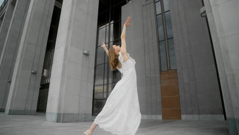 woman dancing in front of a modern building