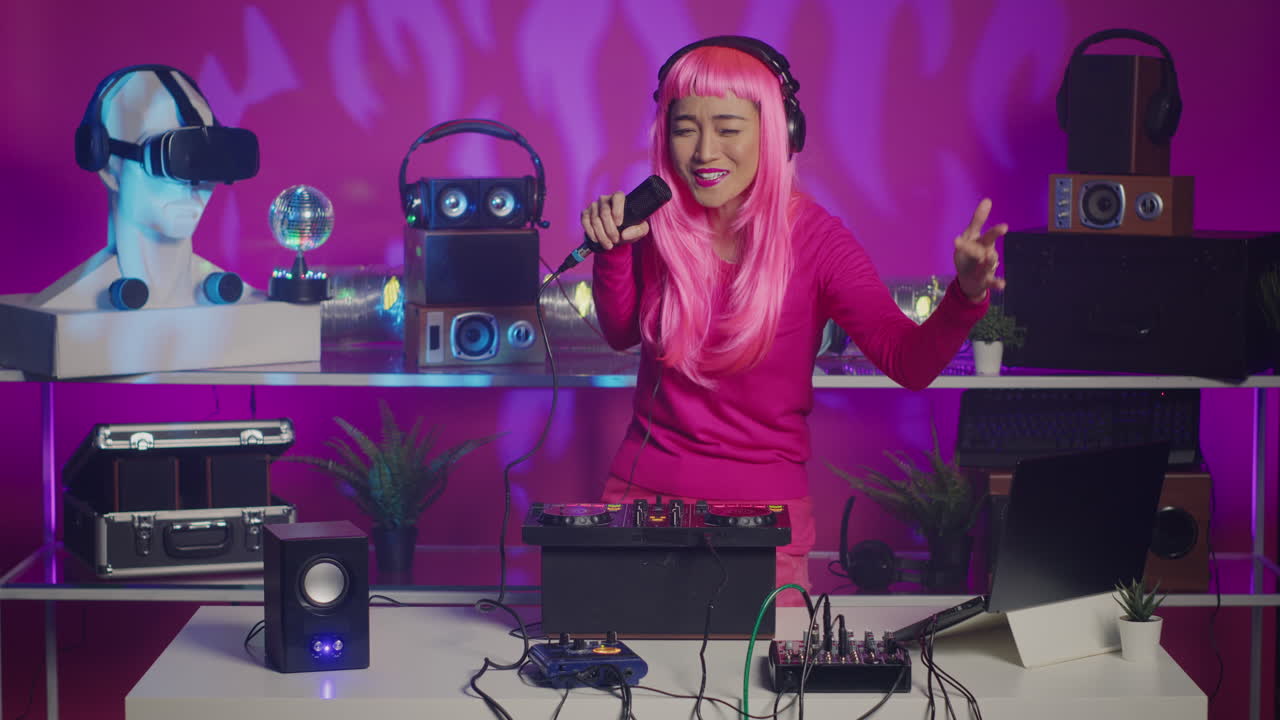 Woman with Pink Wig DJing with Microphone and Electronic Music Equipment