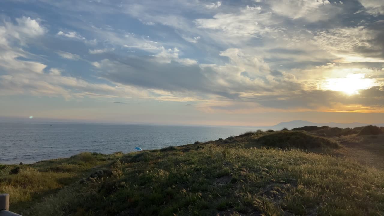 Walking on a wooden path on a southern Spanish beach in Marbella, with stormy skies.