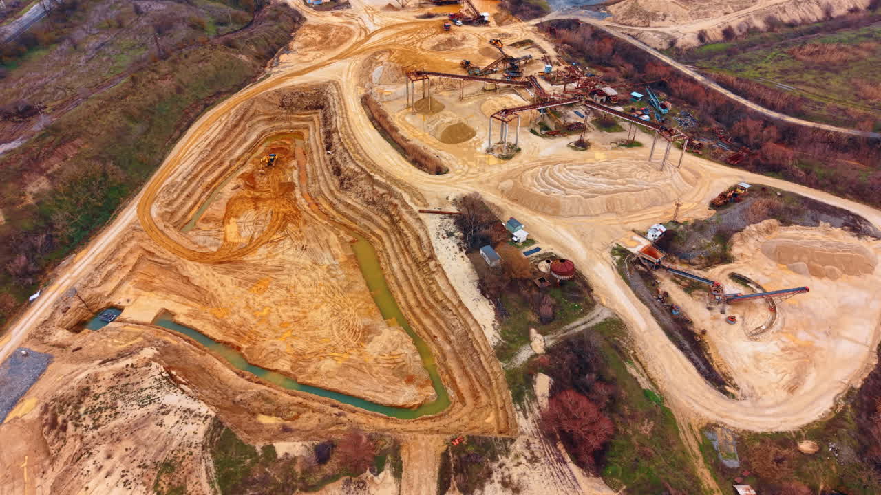 Sand processing area and pit. High angle shot showing extraction pit, conveyor systems, and processed sand mounds
