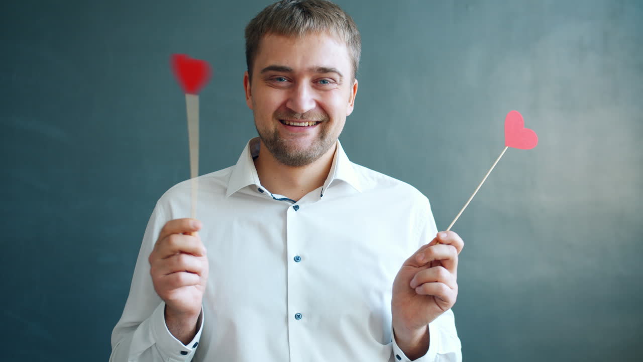 Man holding red hearts