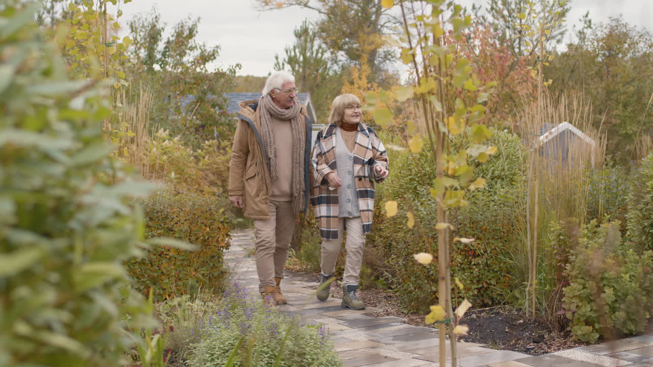 Elderly Couple Enjoying an Autumn Walk in the Garden