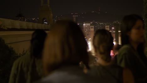 night view of a city with people walking on the street