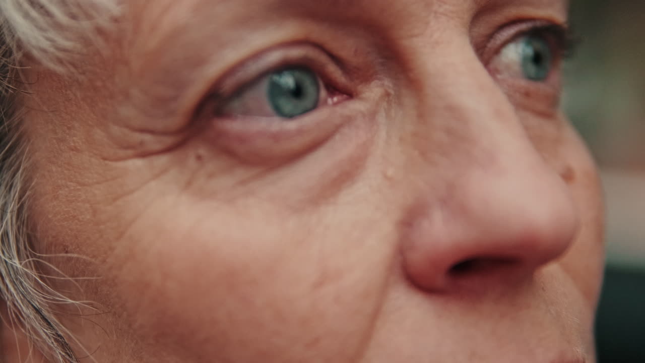 Close-up of Elderly Woman's Blue Eyes and Wrinkled Face