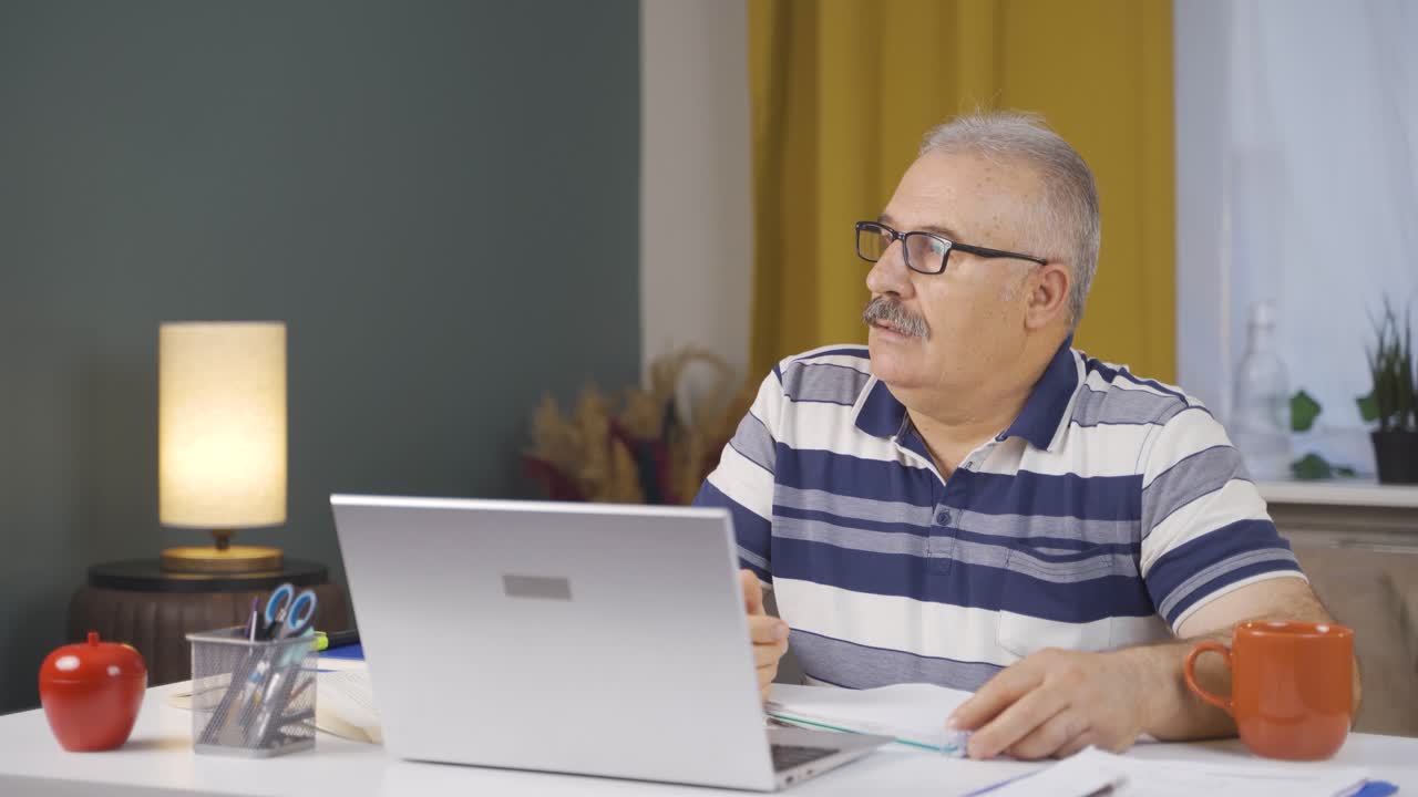 Home office worker old man stressed and thoughtful.