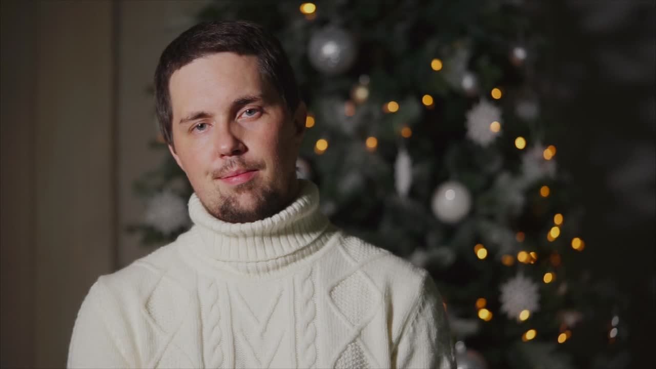 Man in front of Christmas tree
