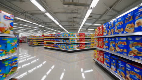 empty supermarket aisle with stocked shelves