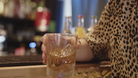 bartender serving whiskey at a bar
