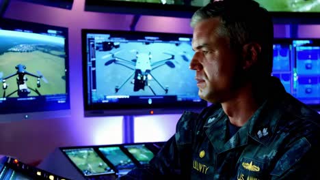 military officer monitoring drone operations in a control room