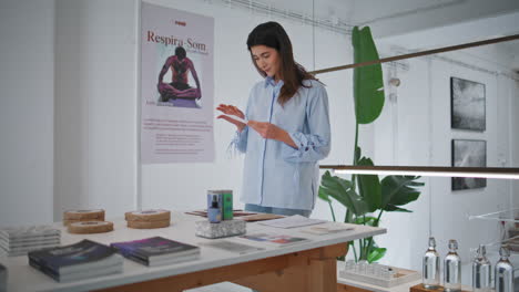 woman waiting spa lobby checking items. thoughtful client visiting yoga fitness