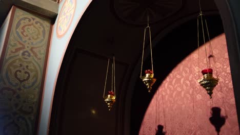 ornate church interior with hanging lamps