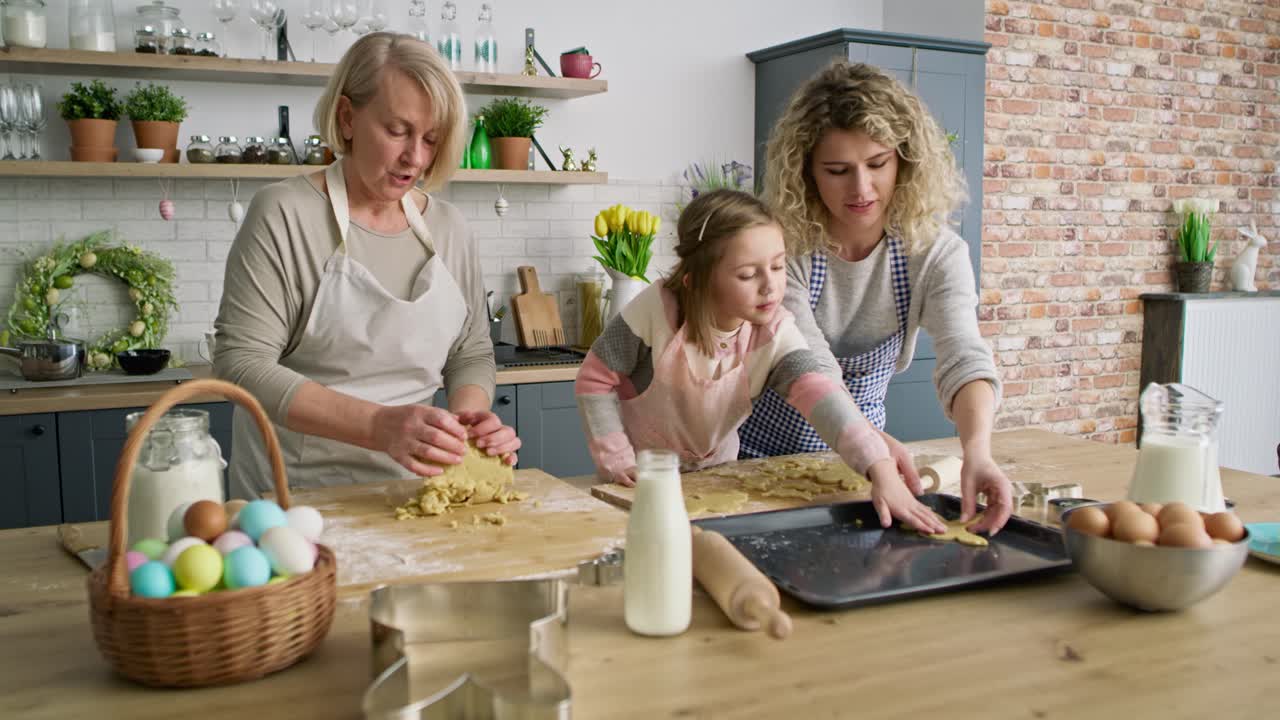 Video of three generations of women preparing Easter cookies together