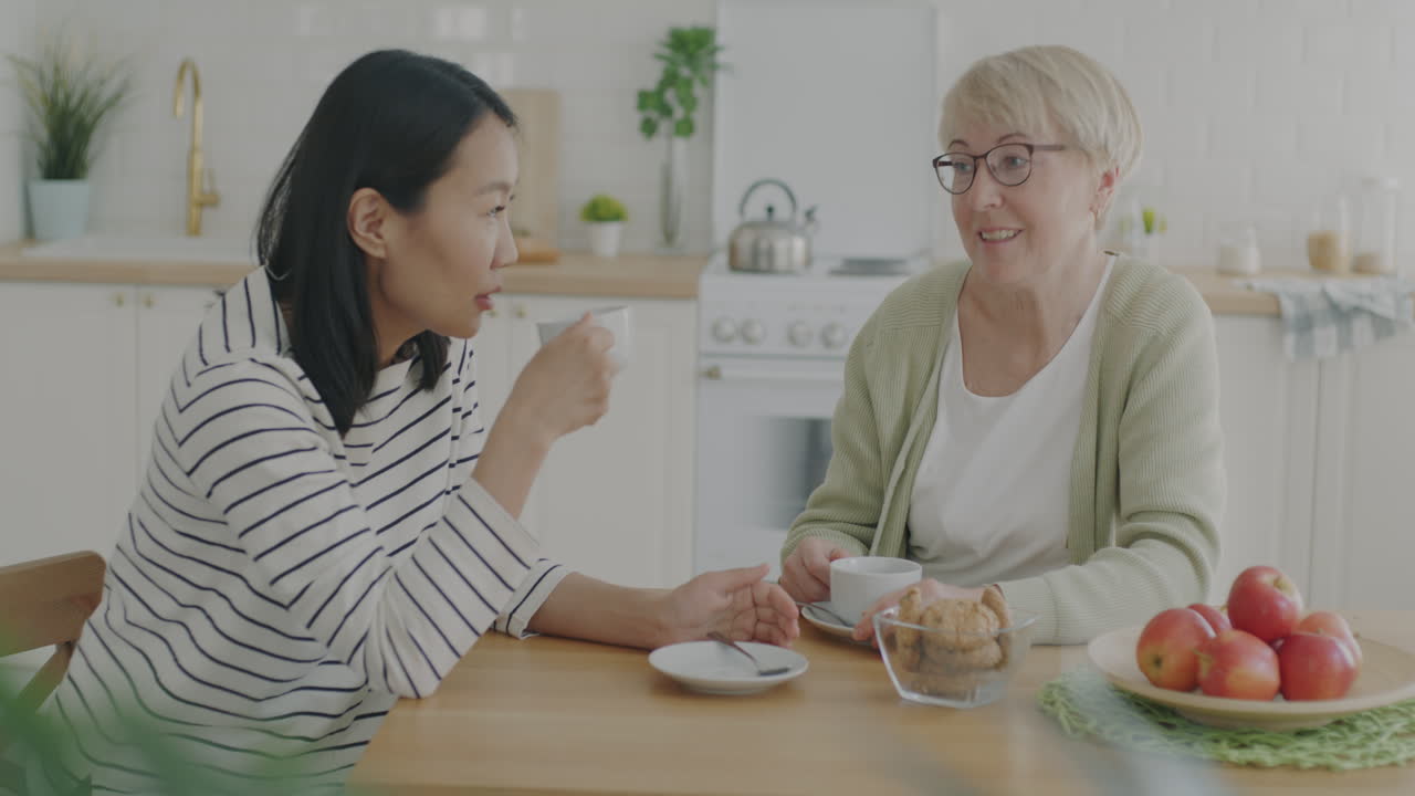 Mother and Daughter Enjoying a Coffee and Chat