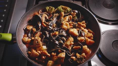 healthy cooking chicken noodles with vegetables - overhead view