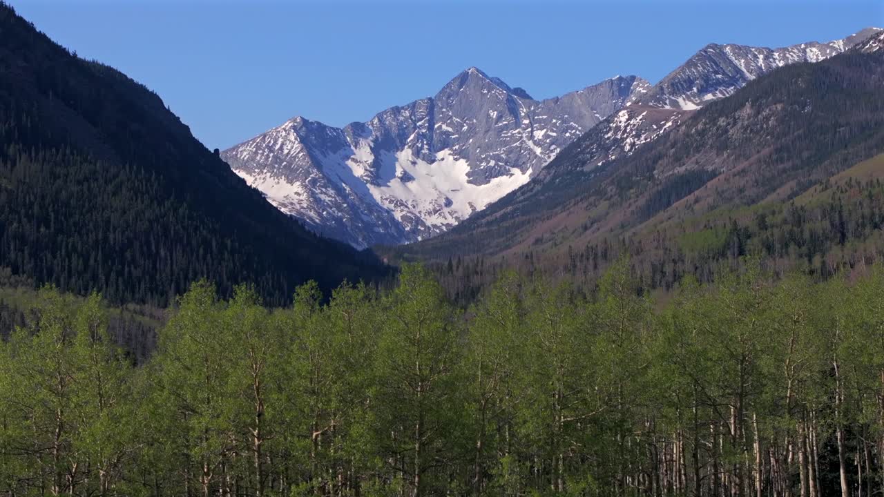 Spring Summer aspen trees San Isabel forest Huerfano River valley ranch Blanca Peak Mt Mount Lindsey Lily Lake trailhead Sangre de Cristo Range Colorado aerial drone Rocky Mountains upwards motion