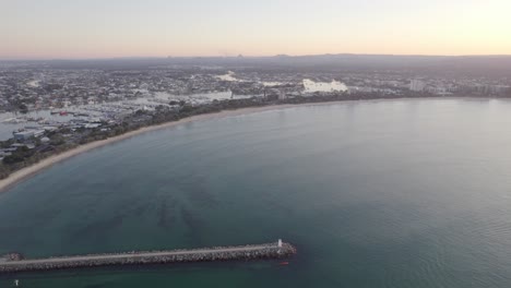 peaceful day at rock wall point cartwright in the sunshine coast of queensland, australia aerial pull back shot