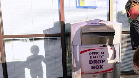 Father-Teaching-Daughter-How-to-Vote-in-Election-at-Official-Ballot-Drop-Box-by-Casting-Ballot-Letter-with-Child-for-Democratic-Mail-in-Voting