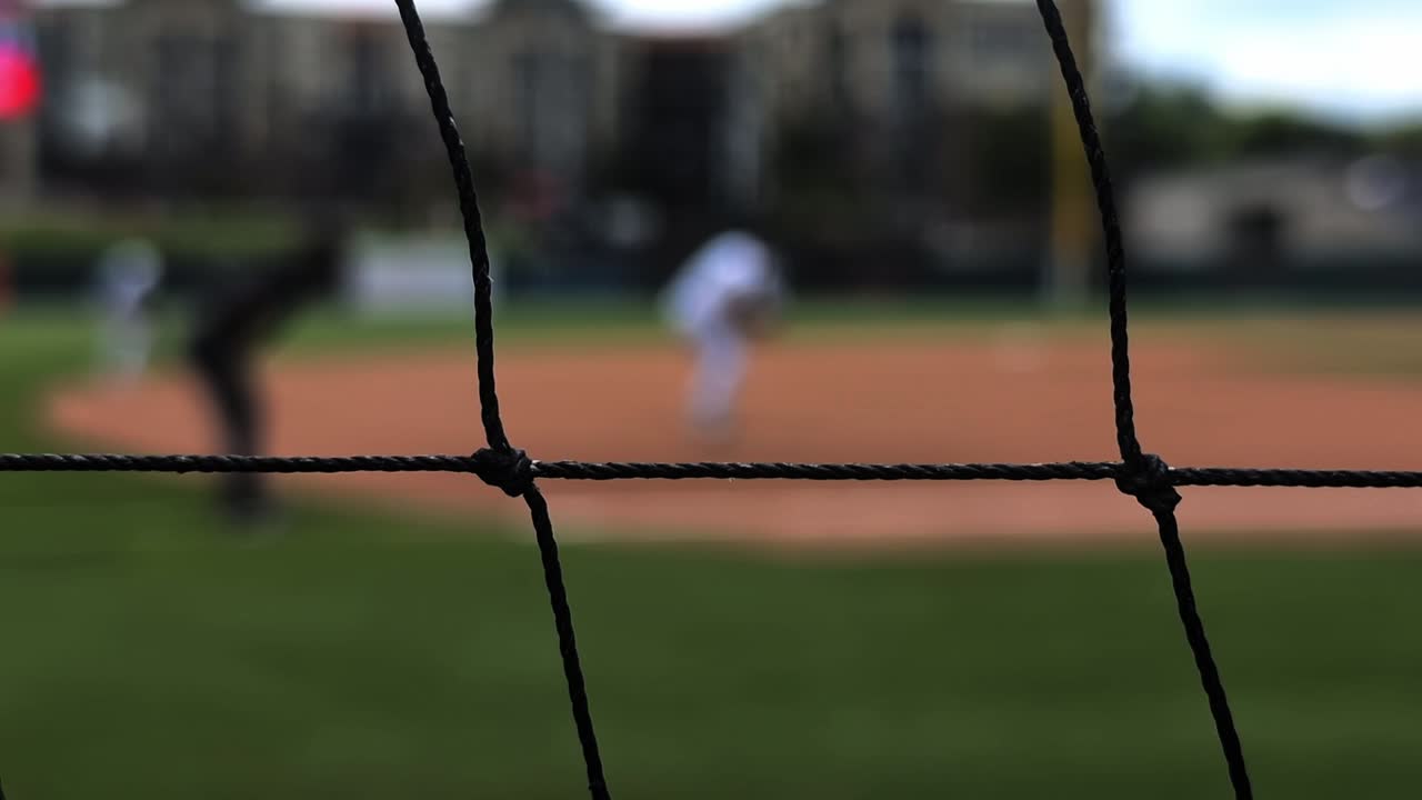 Baseball infielders and umpire get ready for play, then ease off