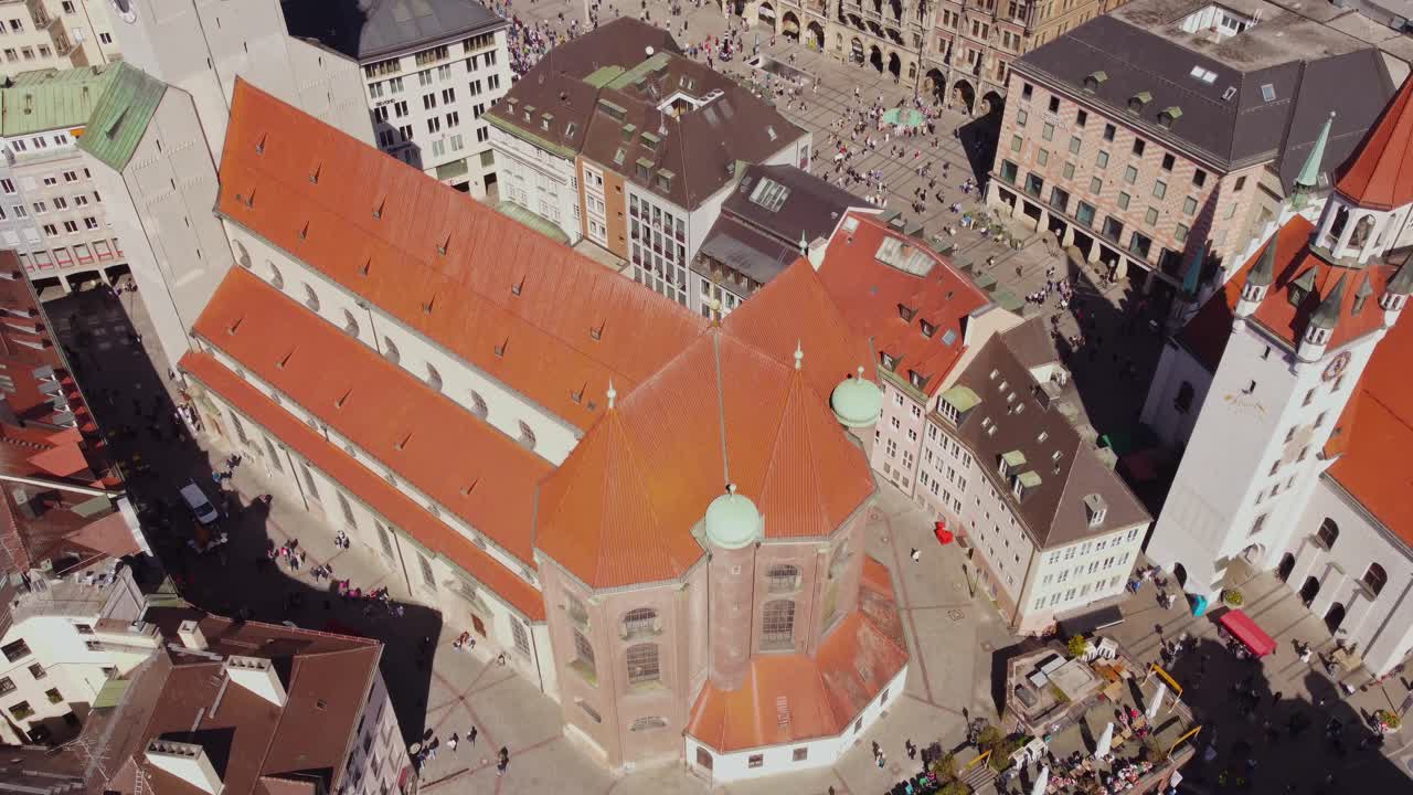 St. Peter Church, New Town Hall And Tourists At Marienplatz In Munich, Germany. - aerial shot